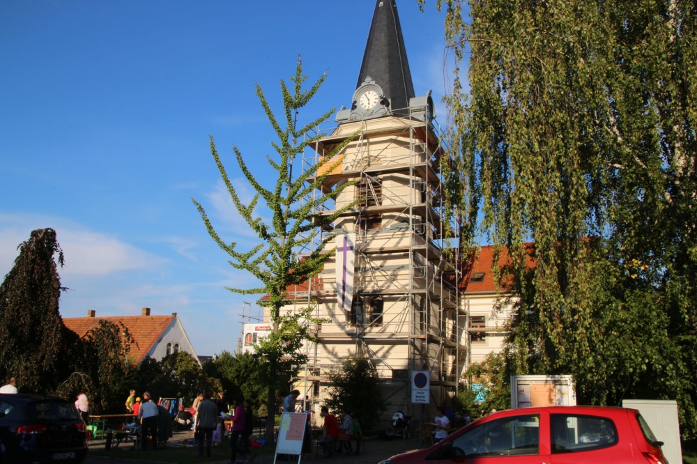 Kirche mit Gerüst und Kirchenfahne